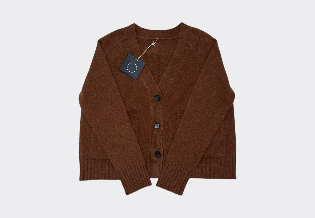 Front product flat lay of hazelnut brown v neck cashmere cardigan with three buttons. Swing tag visible and circle of stitches logo from Irish knitwear brand Sphere One