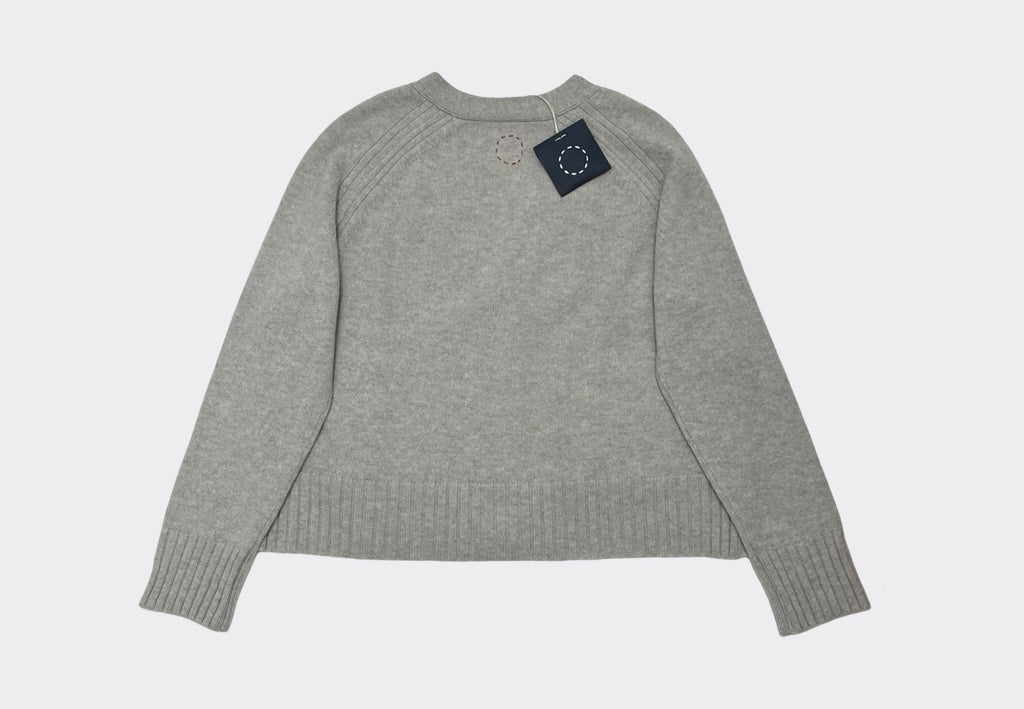 Back product flat lay of boxy grey  cashmere cardigan with ribbed detailing. Swing tag visible and circle of stitches logo from Irish knitwear brand Sphere One