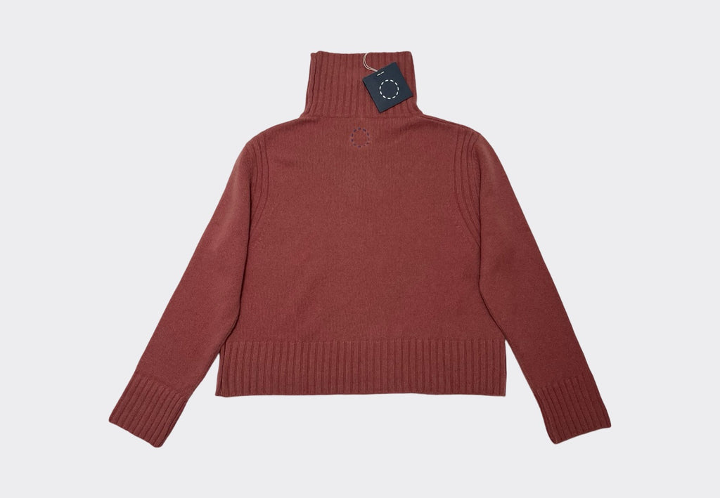 Back product flat lay of terracotta pink coloured high rib neck cashmere sweater with navy circle of stitches logo from Sphere One 